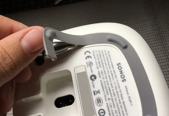 Peeling the rubber foot strip off the base
