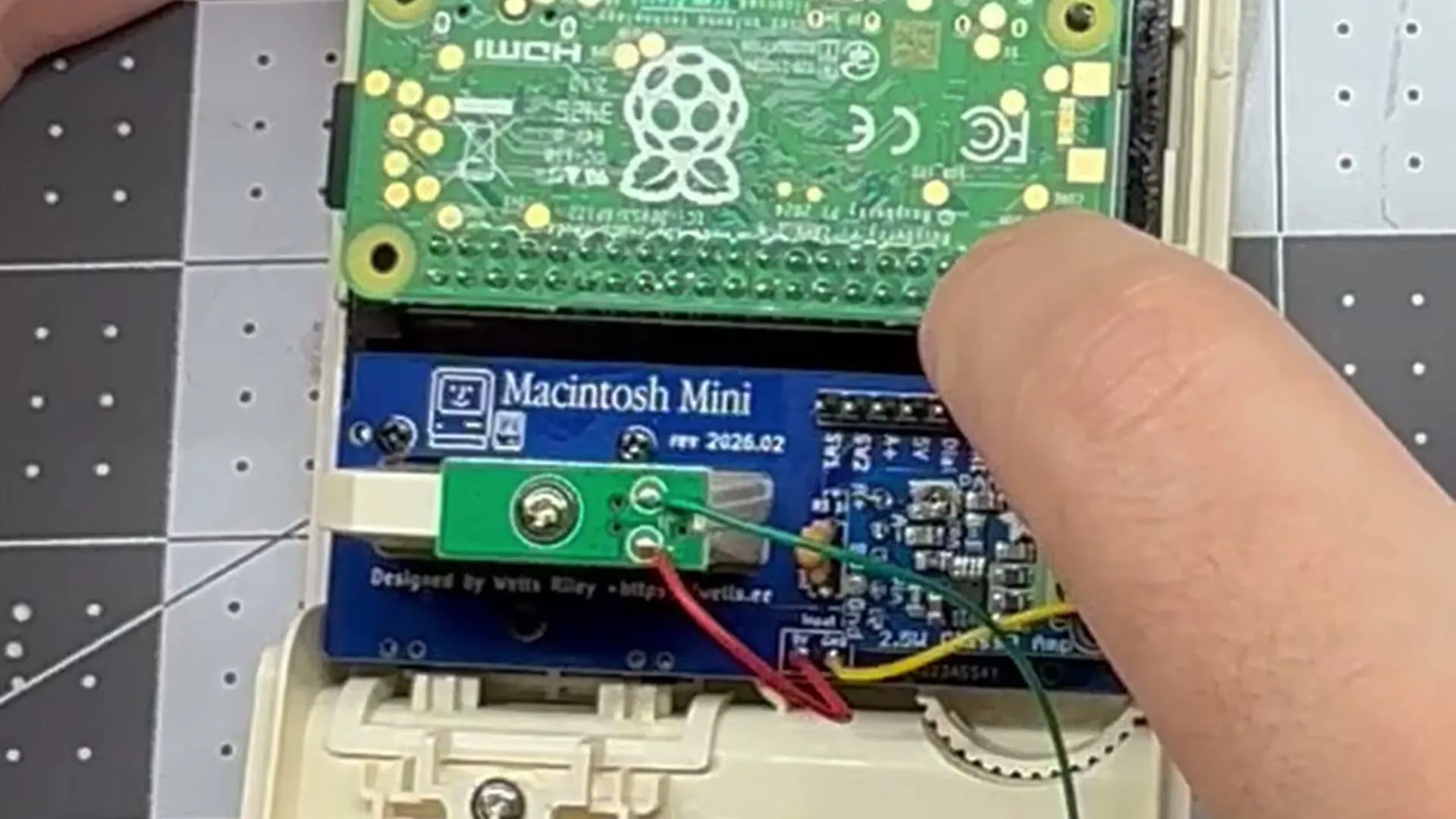 A Raspberry Pi Zero seated on the Macintosh Mini board inside the case